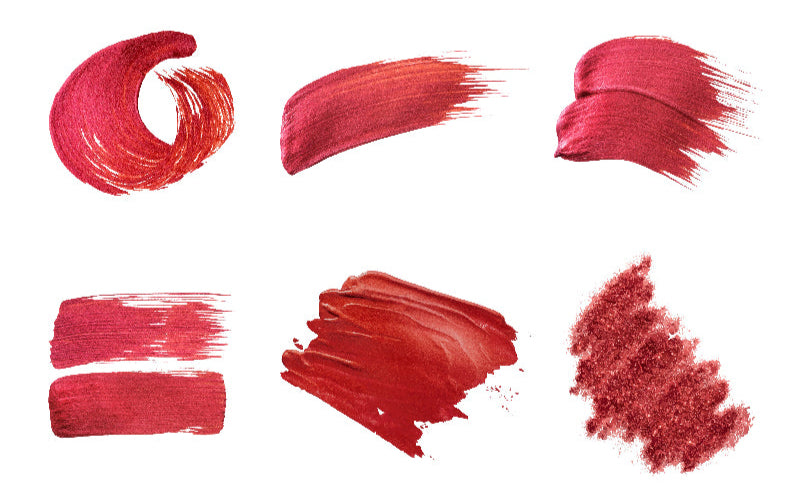 Collection of red lipstick swatches on a white background